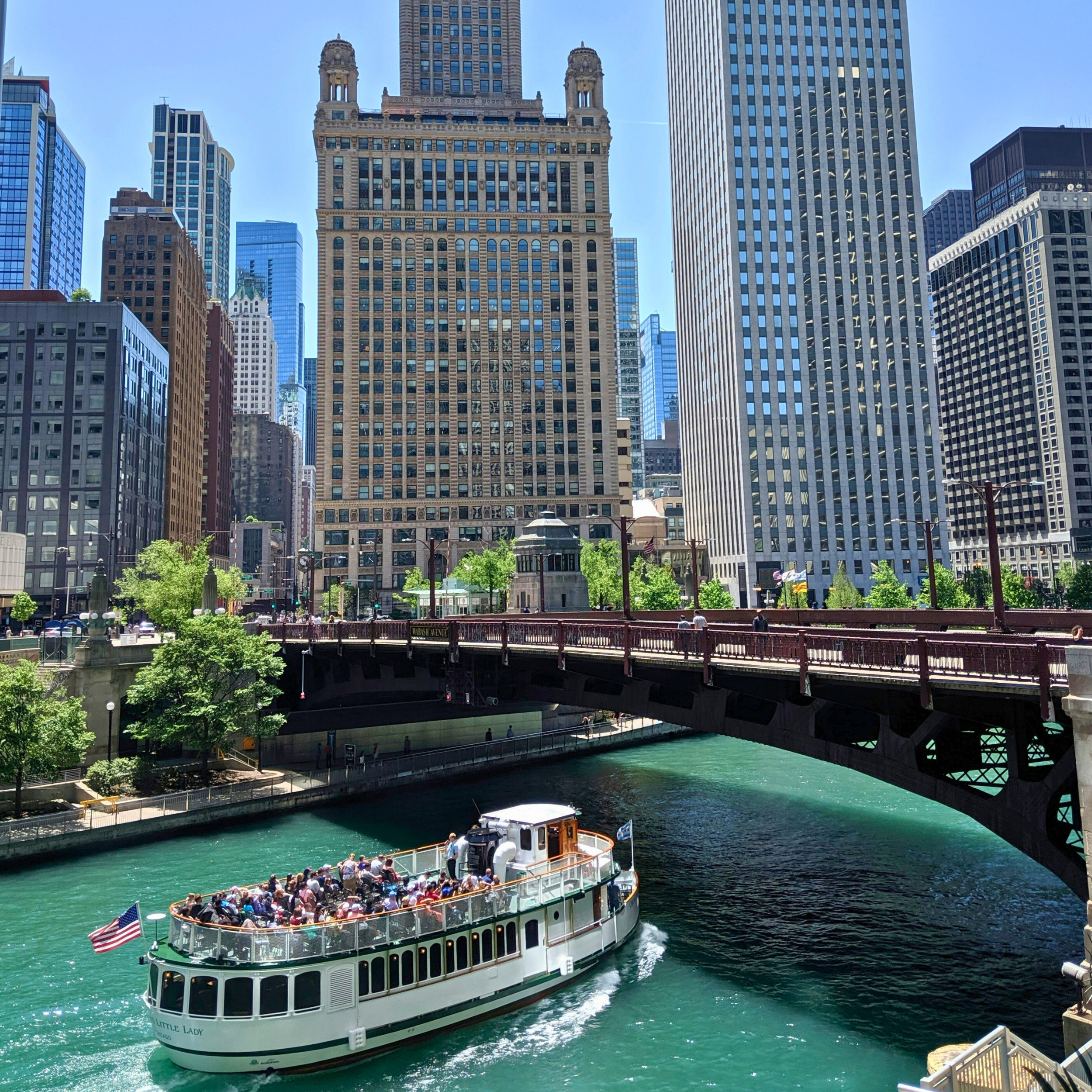 A boat cruises down the Chicago River. Many tours will go this same route and are the perfect addition to a weekend in Chicago itinerary.
